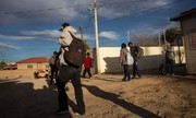Imigrantes recém deportados para o México andam próximo a fronteira com o Estados Unidos 